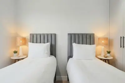 two beds sitting next to each other in a room at Cape Signature Villa in Cape Town