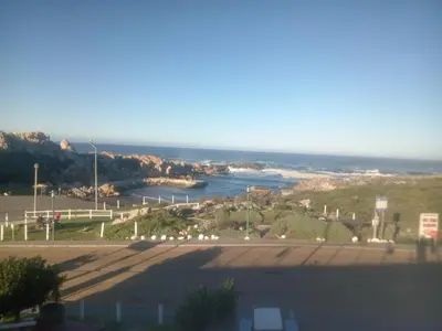a view of the ocean from a parking lot at Starfish Cottage in Kleinmond