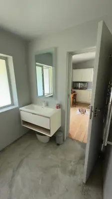 a white bathroom with a sink and a mirror at Large and spacious family home is leafy suburb in Stellenbosch