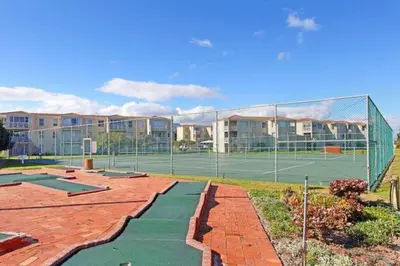 a tennis court with two tennis courts at Hermanus Homestay in Hermanus