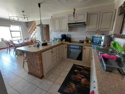 a kitchen with a sink and a counter top at HuisieBydieC in Hermanus