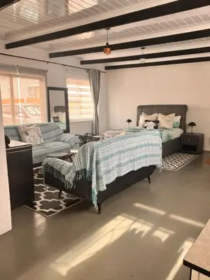 a bedroom with a bed and a couch at Cape Comfy Hidden Home in Cravenby
