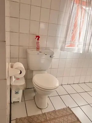 a bathroom with a toilet with a soap bottle on it at Cape Comfy Hidden Home in Cravenby