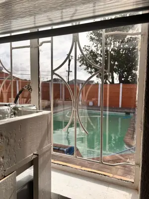 a window with a view of a swimming pool at Cape Comfy Hidden Home in Cravenby
