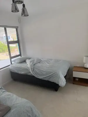 a bedroom with two beds and a window at Mountain View 2-Bedroom Home Near the Beach in Pringle Bay in Pringle Bay