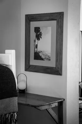 a picture on a wall with a table in a room at Palm La Vie in Worcester