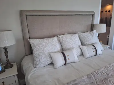 a white bed with white pillows on it at Boutique Inn - Serenity in Gordonʼs Bay
