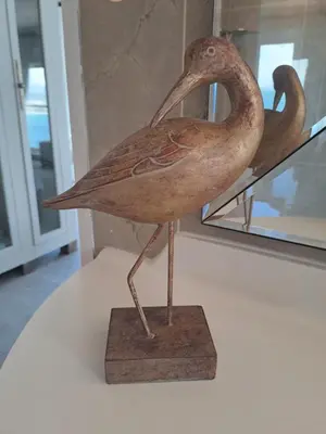 a wooden bird statue sitting on top of a table at Boutique Inn - Serenity in Gordonʼs Bay