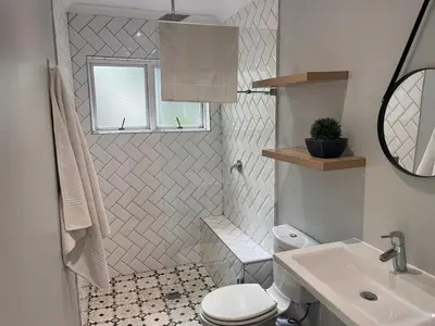 a bathroom with a toilet and a sink at Secluded Silver Mile with solar back-up in Cape Town