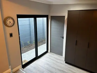 a room with a clock on the wall and a door at Alicante self-catering 2 Bedroom apartment sleeps 4 in Worcester