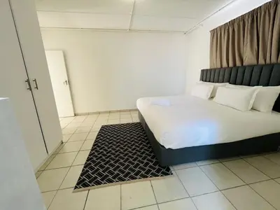 a bedroom with a large bed in a room at Eversham Boutique in Cape Town