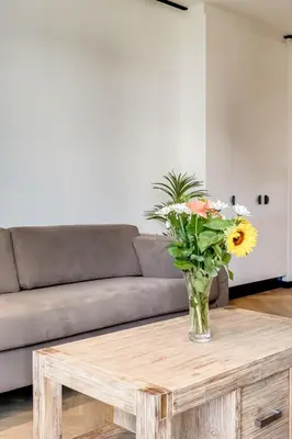 a vase of flowers sitting on a coffee table at Palmcrest Eden in Cape Town