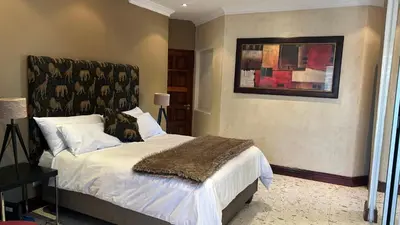 a bedroom with a bed and a picture on the wall at Clements Apartment in Avondale