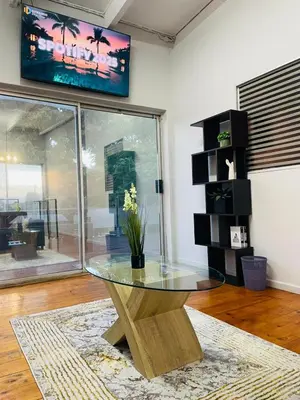 a table with a glass top in a room at claremont guesthouse in Cape Town
