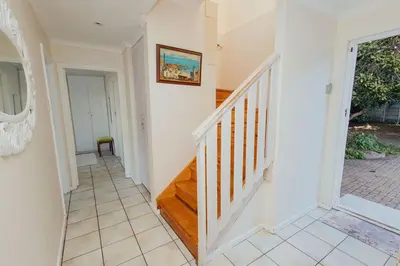 a hallway with a staircase in a home at Seabreeze in Hermanus