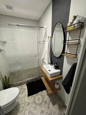 a bathroom with a sink and a mirror at The Den Apartements Stellenbosch in Stellenbosch