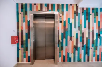 a elevator in a building with a colorful wall at 10 at The Alxndr - Stellenbosch Central in Stellenbosch