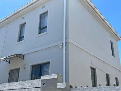 a white building with windows on the side of it at Valley Escape in Cape Town
