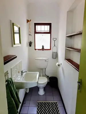 a bathroom with a toilet and a sink at Serene, cosy stay with a mountain view in Greyton