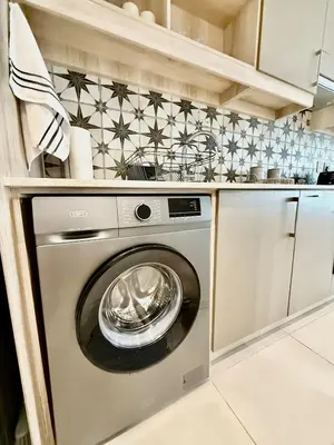 a kitchen with a washing machine in a kitchen at 22 at The Den in Stellenbosch