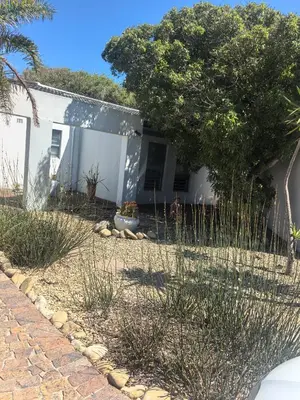 a white house with a tree in front of it at 22 on breezand in Cape Town