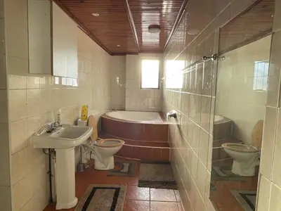 a bathroom with two toilets and a tub and a sink at AAA Luxury Homes Goodwood Cpt in Elsiesrivier