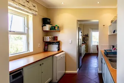 a kitchen with a counter top and a window at Porcupine Creek in Pringle Bay