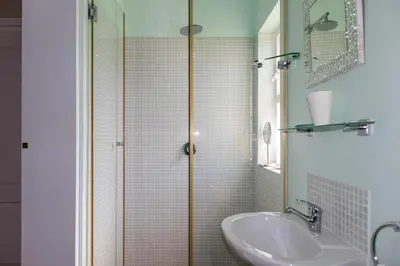 a bathroom with a sink and a shower at Porcupine Creek in Pringle Bay