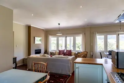 a living room with a bed and a couch at Porcupine Creek in Pringle Bay