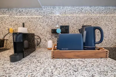 a kitchen with a counter with a coffee maker and appliances at 232 Paarl Studio With AC and Onsite Parking in Paarl