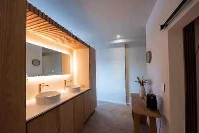 a bathroom with two sinks and a large mirror at Villa Solara, 6 bedroom Vacation Villa with sea view in Gordonʼs Bay