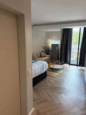 a bedroom with a bed and a couch in a room at Urban Ridge in Cape Town