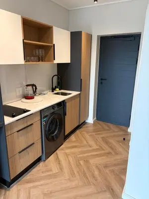 a kitchen with a washing machine and a washer at Urban Ridge in Cape Town