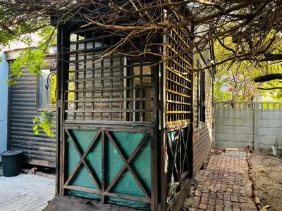 an old wooden gate in front of a house at Cross Road Cabin in Cape Town