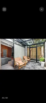 a living room with two chairs and a couch at Beach House Living in Gordonʼs Bay