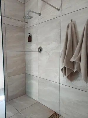 a shower stall with a glass door with towels at 7th Heaven Guest Unit in Paarl