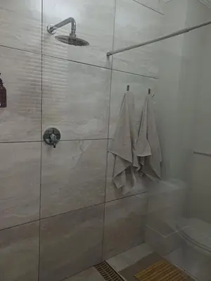 a shower with a glass door with towels at 7th Heaven Guest Unit in Paarl
