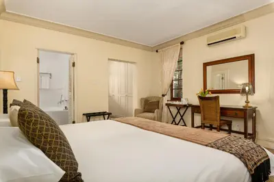 a hotel room with a bed and a desk at Gable Manor by Neighbourgood in Franschhoek