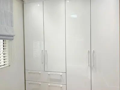 a white closet with white cabinets in a room at Instellies Self Catering Apartment in Stellenbosch