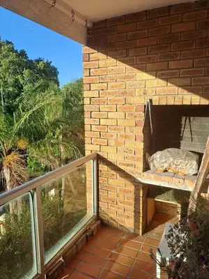 a patio with a brick oven on a balcony at Central 3rd Floor Durbanville Apartment in Durbanville