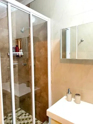 a bathroom with a shower and a sink at Olly-Pops Cottage in Tygerberg Hills