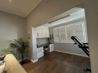 a living room with a couch and a table in it at A home away from home near the beach in Strand