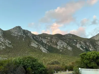 a view of a mountain range with trees and clouds at Mountain View Studio Hermanus in Hermanus