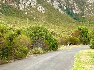 an empty road in front of a mountain at Mountain View Studio Hermanus in Hermanus