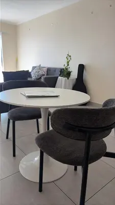a white table and chairs in a living room at Delightful Retreat in Parklands,Cape Farms,Cape Town in Cape Town