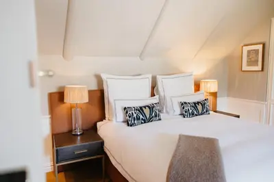 a bedroom with a large white bed with pillows at Erinvale Estate Hotel & Spa in Somerset West