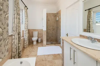 a bathroom with a sink and a toilet at Fir Close 3 bedroom in Hermanus
