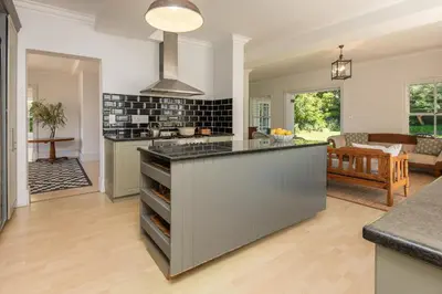 a kitchen with a island in the middle of a room at Fir Close 3 bedroom in Hermanus