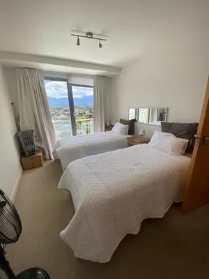 a bedroom with two beds and a large window at Koras little heaven in Strand