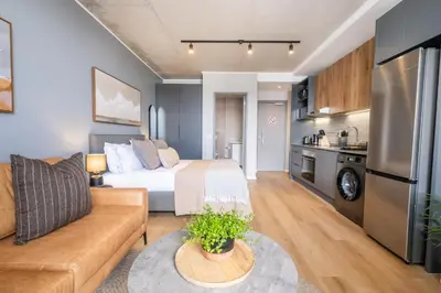 a living room with a bed and a couch at 729 Riverlands - Lux Studio Apartment in Cape Town